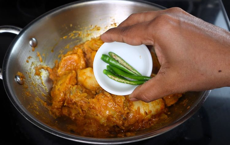 Step 3.1: Add slit green chilies, curry leaves, mint leaves, and the ground masala powder