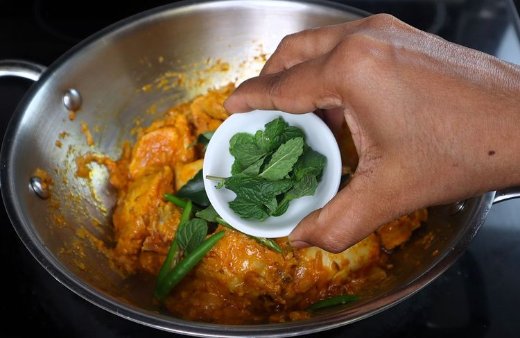Step 3.3: Add slit green chilies, curry leaves, mint leaves, and the ground masala powder