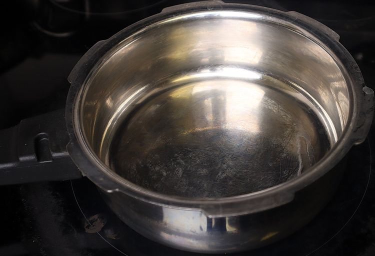 Step 1.1: In a pressure cooker, heat oil over medium to low flame