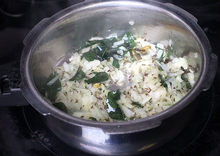 Step 1.4: Add sliced onions and sauté until they are soft and change color