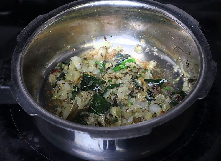 Step 1.4: Add green chillies, ginger and garlic paste, and sauté until the raw smell disappears