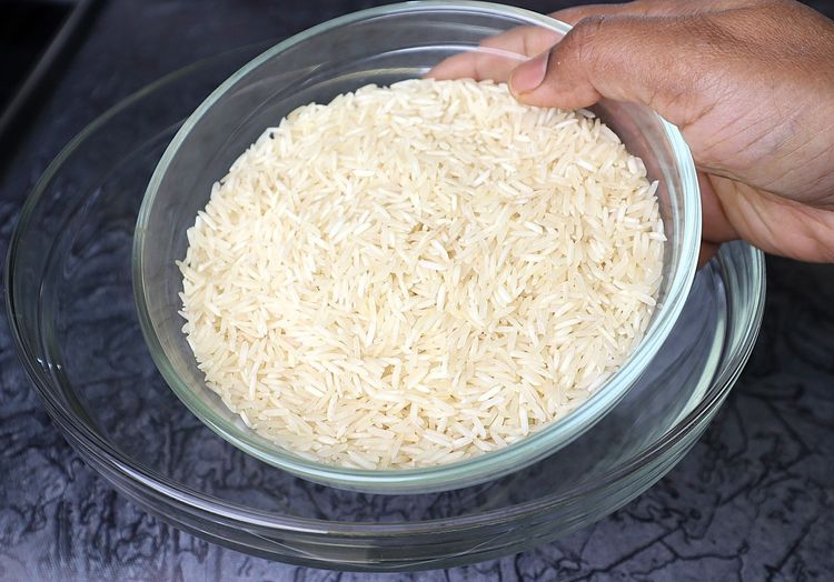 Step 1.2: Add basmati rice to a mixing bowl and rinse it 2-3 times