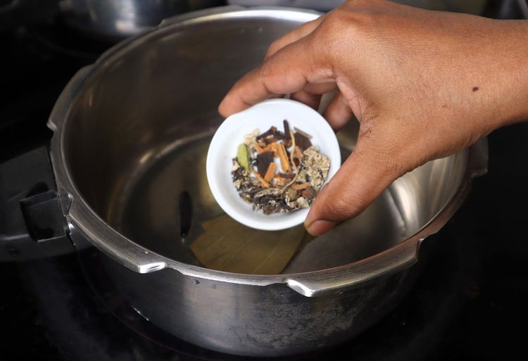 Step 1.3: Add bay leaf, cinnamon stick, cloves, green cardamom, and shah jeera