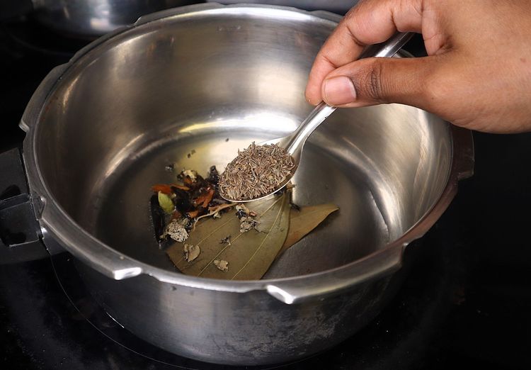 Step 1.4: Once the oil is hot, add bay leaf, cinnamon stick, cloves, stone flower, marati mogga, star anise, and shajeera