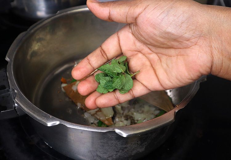 Step 1.2: Add Slit Green Chilli, coriander leaves, and mint leaves and sauté until fragrant