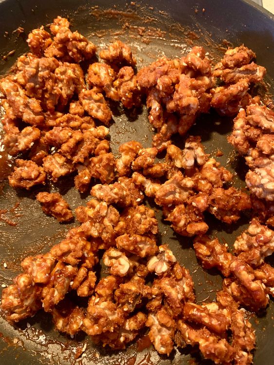 Step 1.2: Add the roasted walnuts to the pan with the melted jaggery