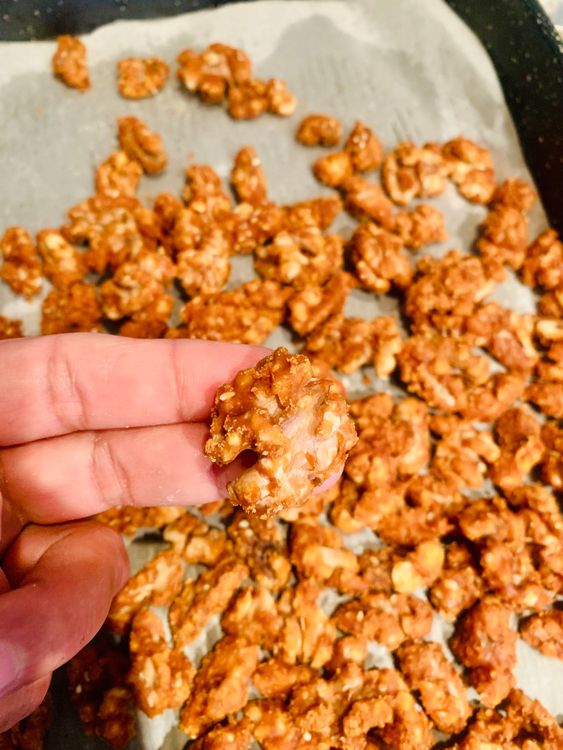 Step 1.1: Immediately spread the coated walnuts on a plate lined with parchment paper, separating them to prevent sticking