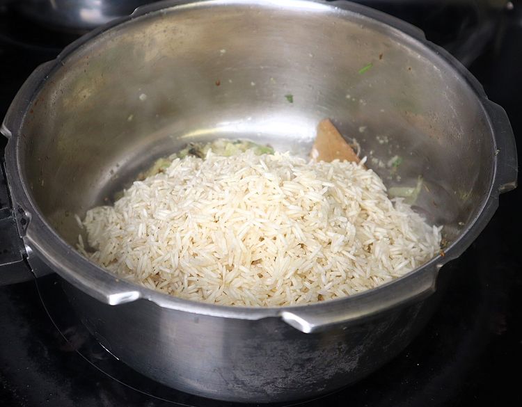 Step 1.2: Add soaked rice without water and sauté for 2 minutes
