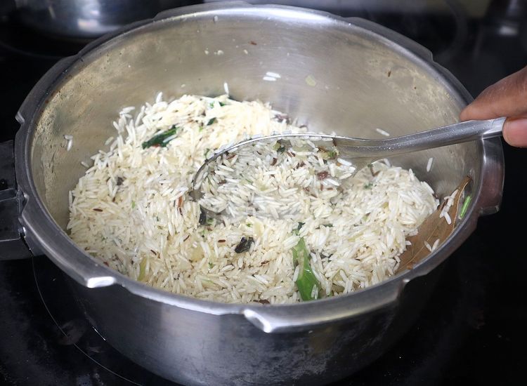 Step 1.4: Add soaked rice without water and sauté for 2 minutes