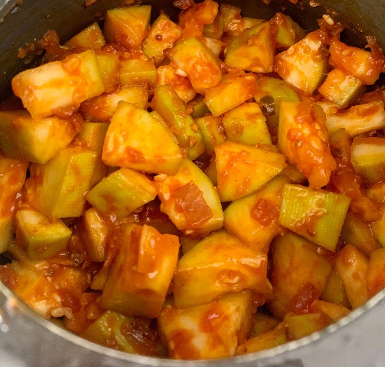 Step 1.1: Add bottle gourd pieces to the cooker and mix nicely