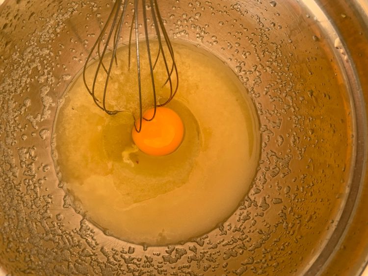 Step 1.1: Add the egg and vanilla extract to the oil-sugar mixture