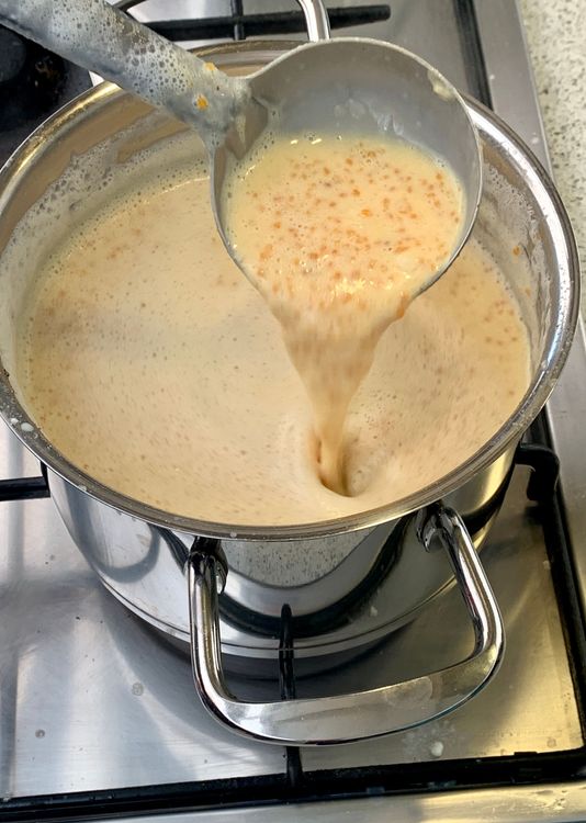 Step 1.2: Add the crushed ladoos to the pan and continue stirring to prevent burning
