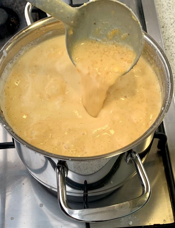 Step 1.3: Add the crushed ladoos to the pan and continue stirring to prevent burning