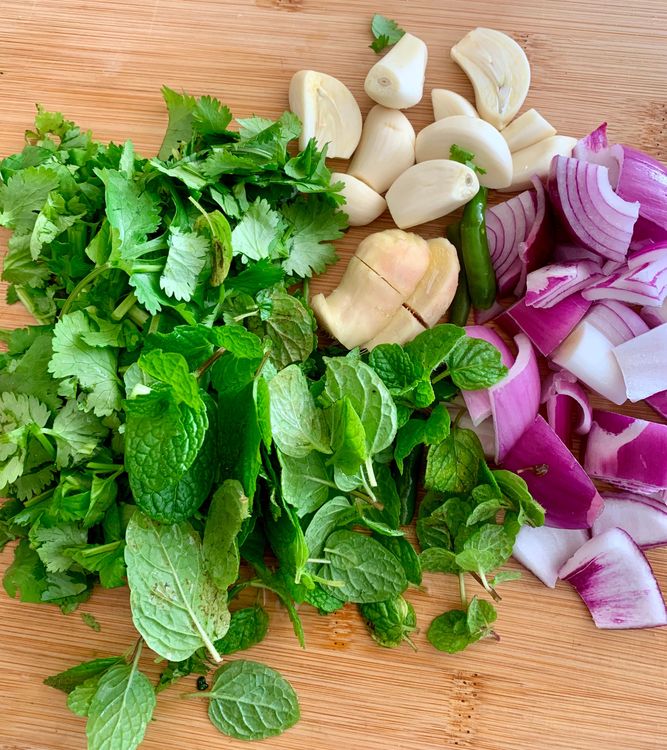 Step 2.1: In a blender, combine the fresh coriander leaves and stalks, mint leaves, onion, green chilies, garlic cloves, ginger, black peppercorns, cumin seeds, cloves, cinnamon stick, turmeric powder, poppy seeds, lemon juice, oil, and salt