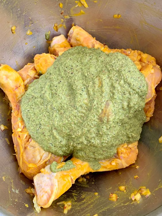 Step 2.1: Marinate the chicken pieces with half of the green masala paste, keeping the rest for later use