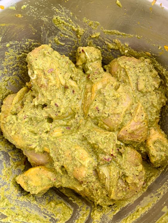 Step 2.2: Marinate the chicken pieces with half of the green masala paste, keeping the rest for later use
