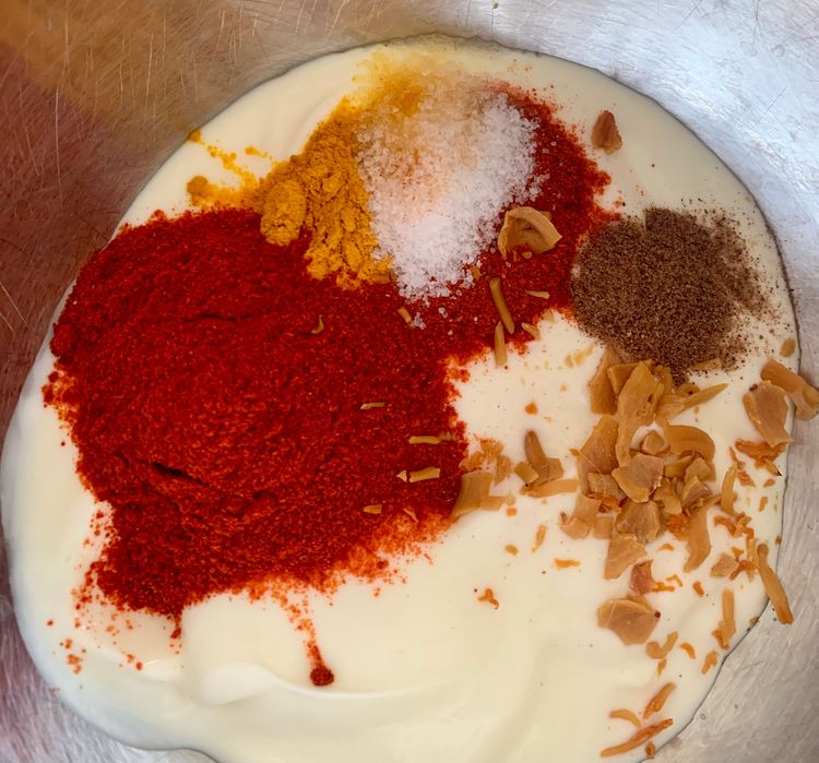 Step 1.1: Whisk curd in a mixing bowl and add red chilli powder, kashmiri red chilli powder, turmeric, nutmeg powder, mace powder and salt