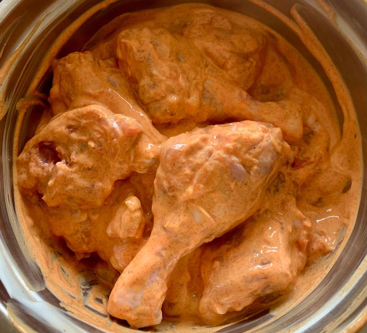 Step 1.1: Coat the chicken pieces with the paste, cover the bowl with a lid, and let it sit for an hour