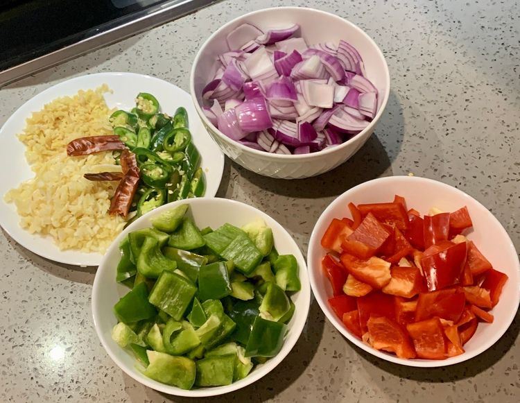 Step 1.1: Dice the red bell pepper, green bell pepper, and onions into cube-shaped pieces