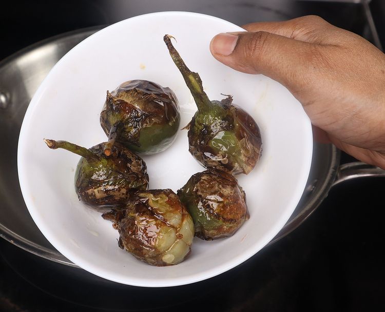 Step 2.5: Once browned, remove the brinjals and set aside