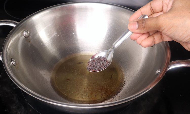 Step 2.1: In the same kadai, add mustard seeds, cumin seeds, urad dal, and chana dal
