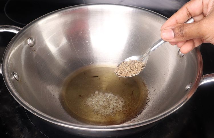 Step 2.2: In the same kadai, add mustard seeds, cumin seeds, urad dal, and chana dal