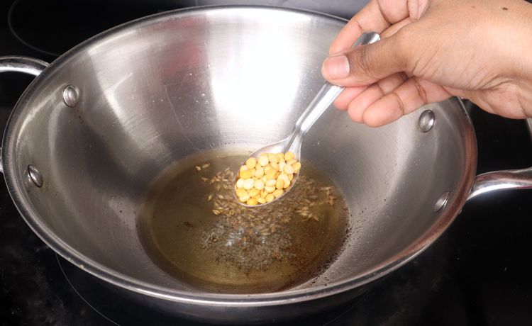 Step 2.3: In the same kadai, add mustard seeds, cumin seeds, urad dal, and chana dal