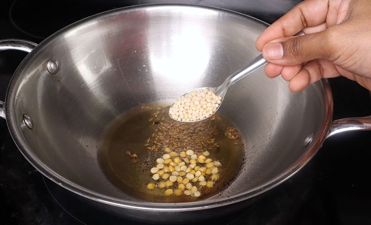 Step 2.4: In the same kadai, add mustard seeds, cumin seeds, urad dal, and chana dal