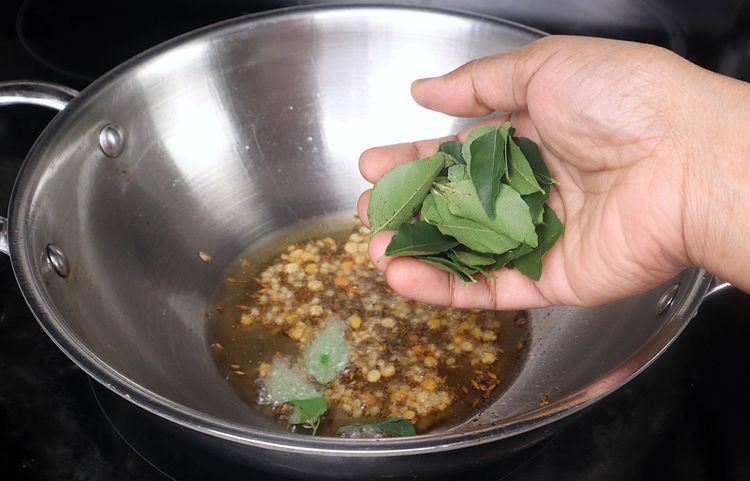 Step 2.1: Add chopped onion, green chili, and curry leaves