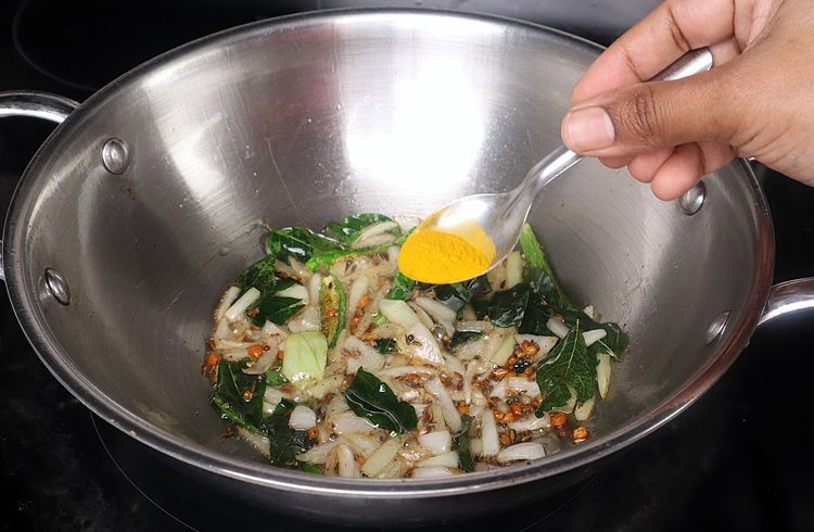 Step 2.1: Add turmeric powder to the kadai and sauté