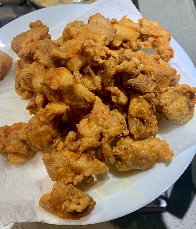 Step 3.1: Use a slotted spoon to remove the fried chicken from the pan and place it on a paper towel-lined plate to drain excess oil