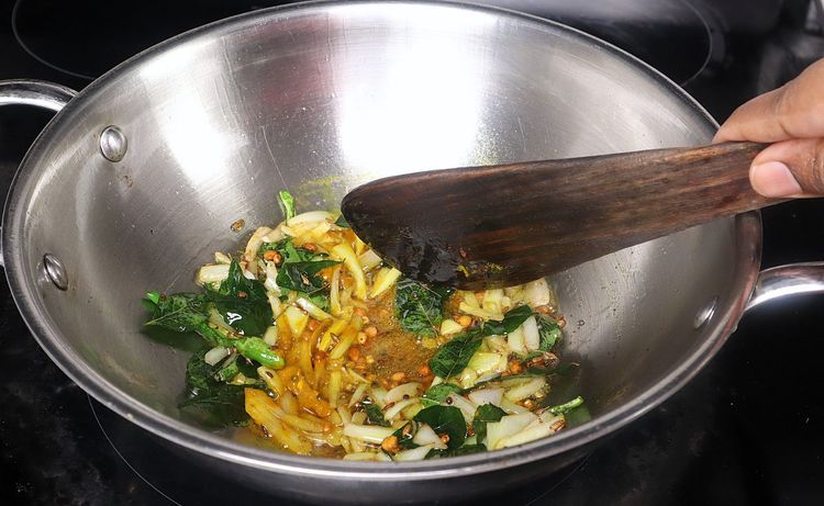 Step 2.2: Add turmeric powder to the kadai and sauté