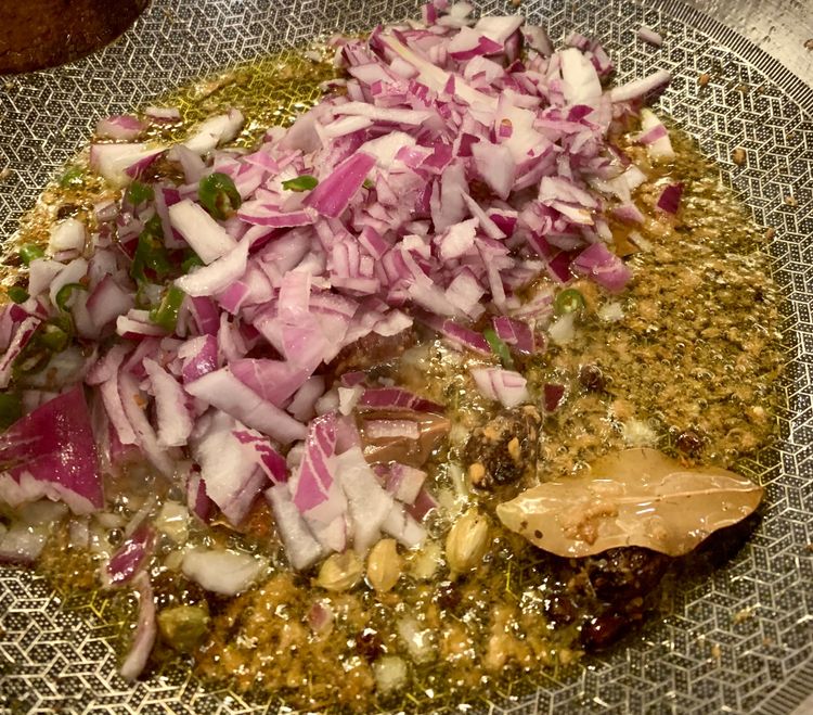 Step 2.1: Add onions and green chillies to the pan
