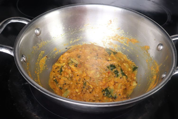 Step 2.7: Add turmeric powder to the kadai and sauté