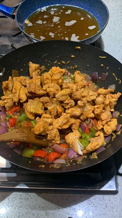Step 3.1: Add the fried chicken to the wok with the vegetables