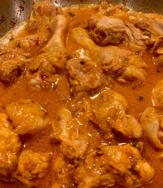 Step 2.1: Add the tomato puree to the pan and let it simmer and cook until the chicken is done and oil releases to the surface