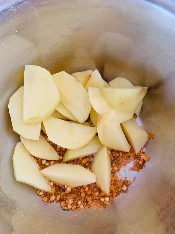 Step 1.1: Add the cut potatoes to the mixing bowl and coat them with the remaining spices