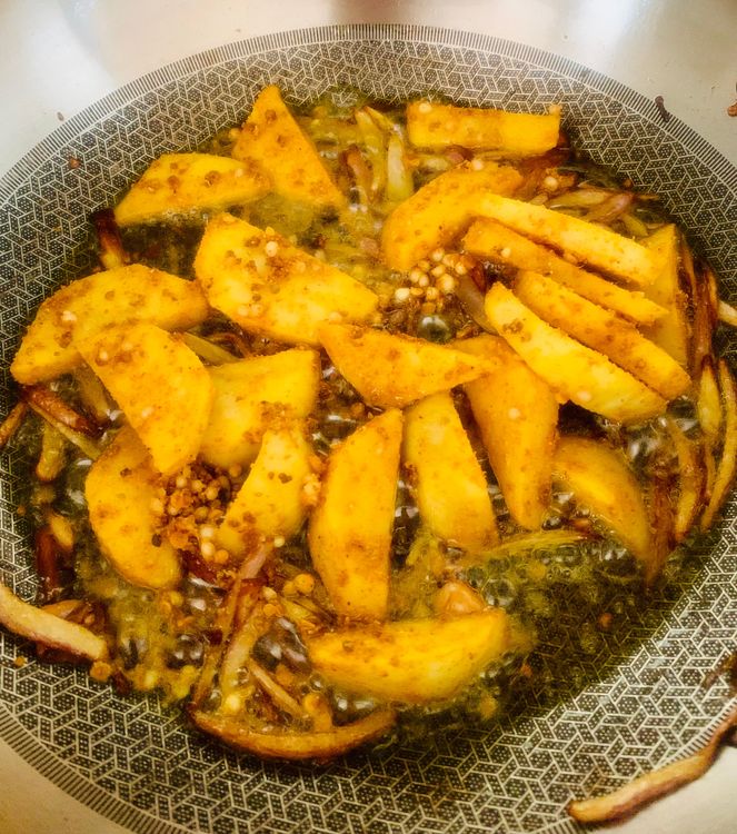 Step 1.1: Add the marinated potatoes to the wok and stir-fry until they are half-cooked