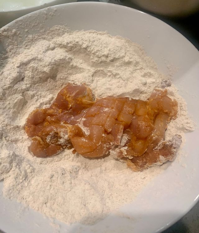 Step 2.1: Coat each marinated chicken fillet with the flour mix, tossing it a few times to ensure an even coating