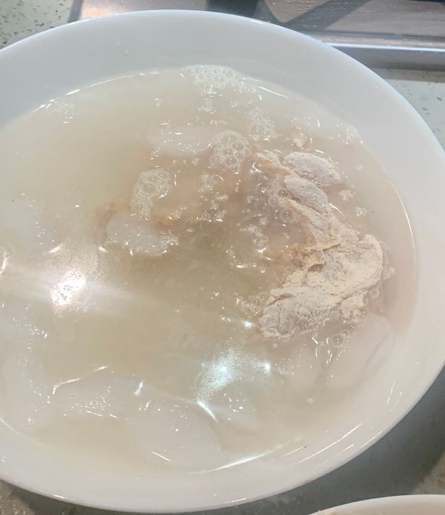 Step 2.1: Dip the coated chicken fillet in chilled water for 10 seconds