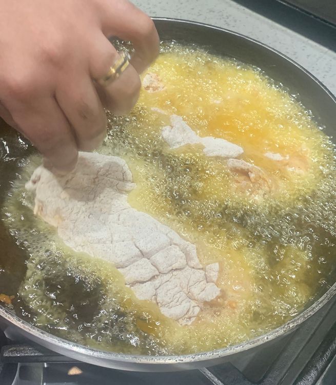 Step 3.1: Gently place the coated fillets into the hot oil, frying them in batches