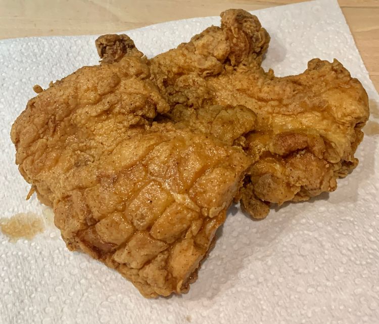 Step 3.1: Take the golden brown chicken fillets out and place them on a kitchen towel to absorb excess oil