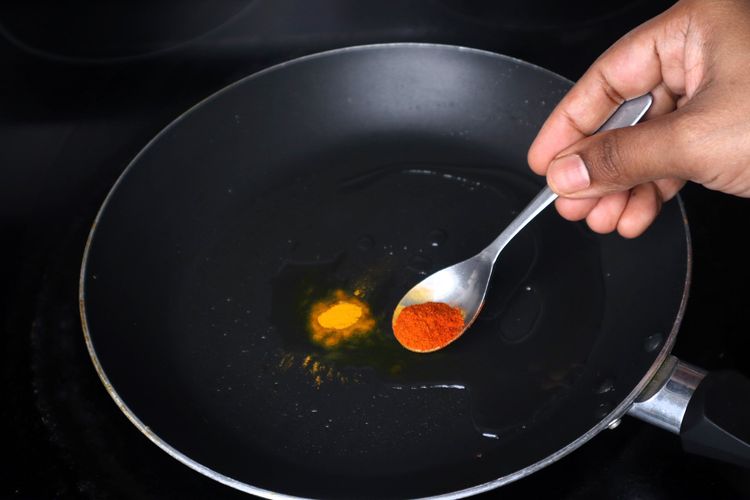 Step 2.3: In the same pan, add 1 tsp oil, turmeric powder, red chilli powder, and salt