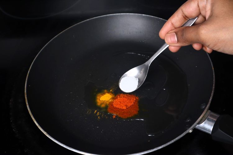 Step 2.4: In the same pan, add 1 tsp oil, turmeric powder, red chilli powder, and salt