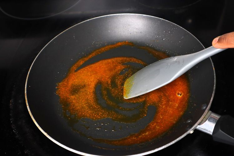 Step 2.6: In the same pan, add 1 tsp oil, turmeric powder, red chilli powder, and salt