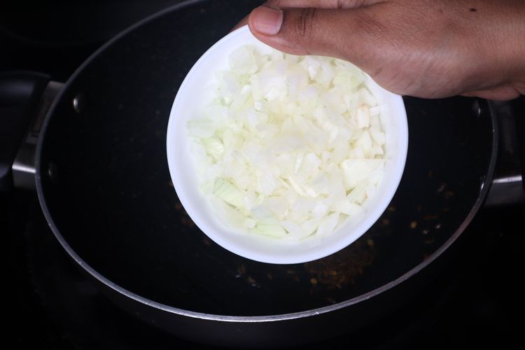 Step 2.1: Add finely chopped onions and sauté until they become soft and translucent