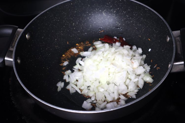 Step 2.2: Add finely chopped onions and sauté until they become soft and translucent