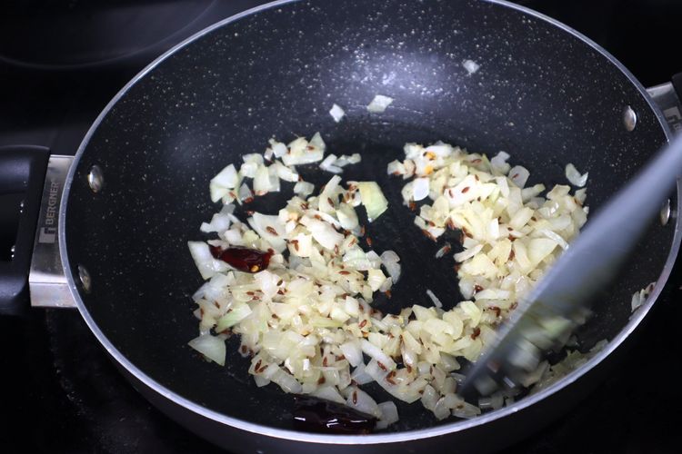 Step 2.4: Add finely chopped onions and sauté until they become soft and translucent