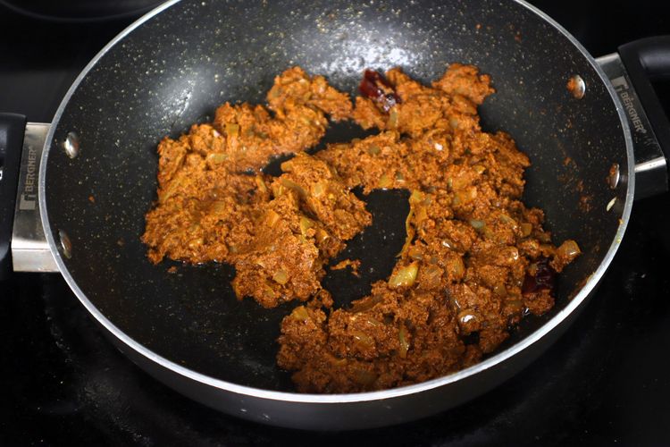 Step 2.4: Add the ground spice paste and sauté until oil separates from the gravy