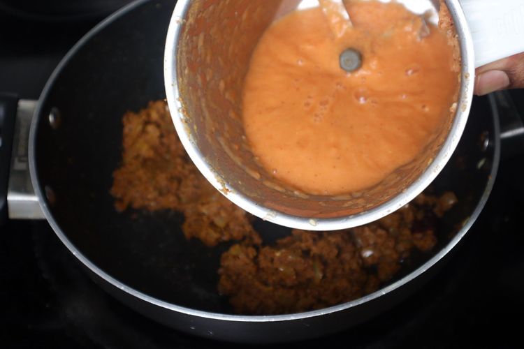 Step 2.1: Add tomato puree and sauté until oil separates